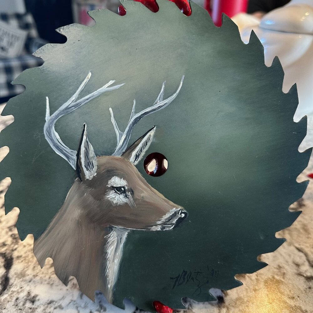Vintage hand painted deer on a circular saw